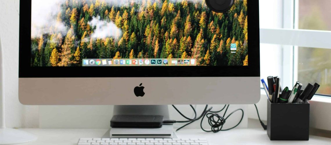 Free Stylish home office workspace featuring a computer setup with accessories. Stock Photo