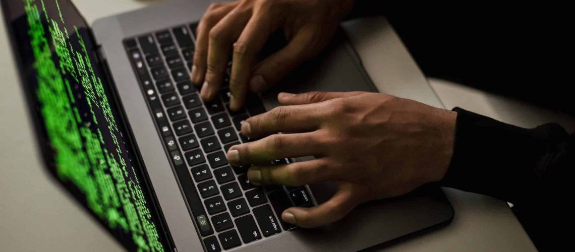 crop-cyber-spy-hacking-system-while-typing-on-laptop